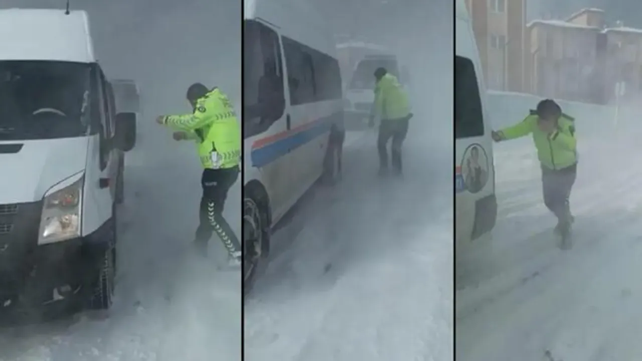 Kar ve tipide yolda kalan öğrenci servisini iterek kurtarmak isteyen polisin zor anları